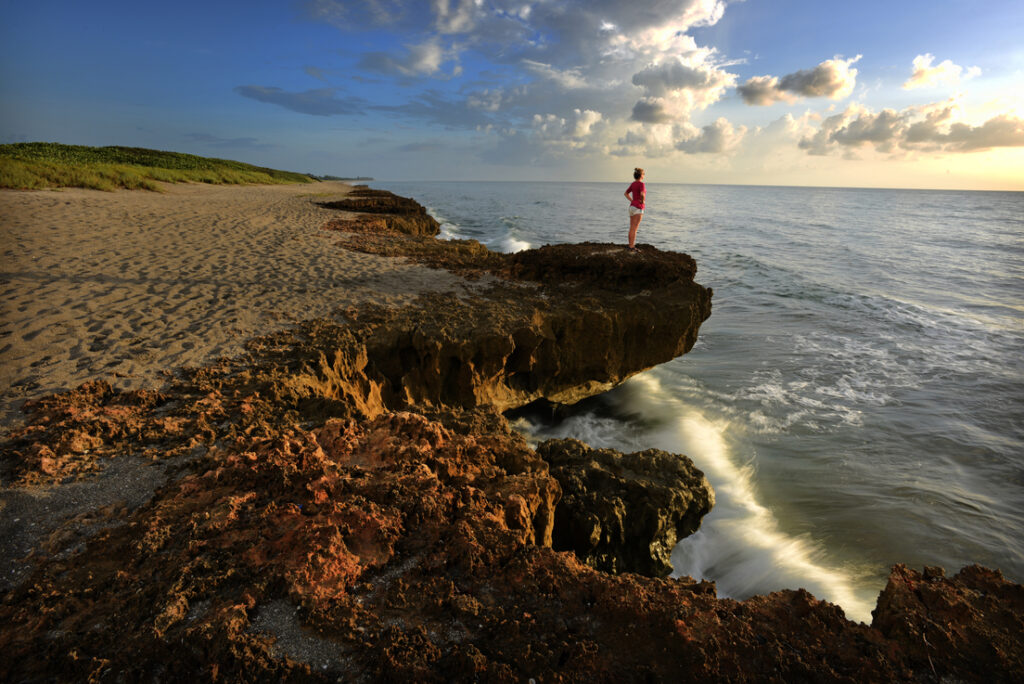 Hobe Sound, FL — Toni Batten, of Jupiter, Fl., takes in the sunrise at Blowing Rocks Preserve. Photo by Peter W. Cross