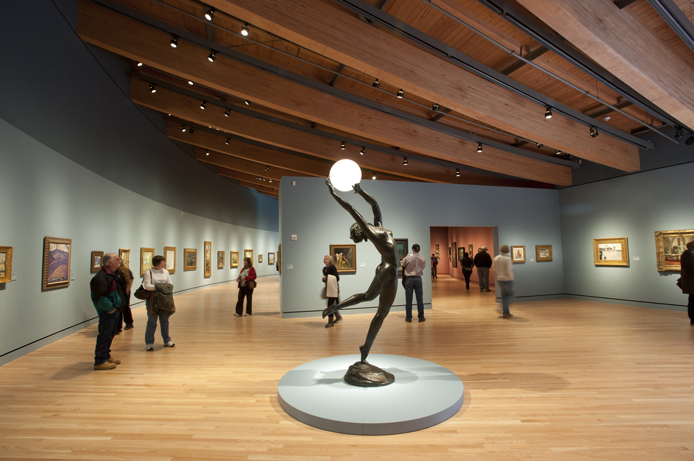 A statue of a woman holding a glowing ball above her head from the Crystal Bridges Museum of American Art in Arkansas.