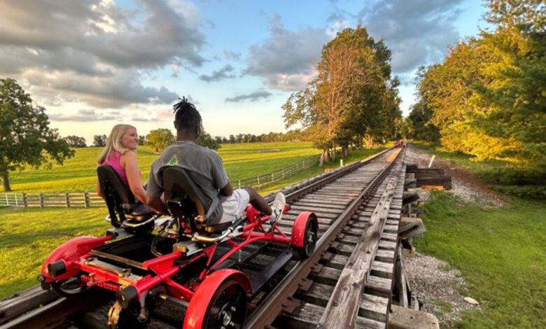 Two people on a rail cart powered by pedals.